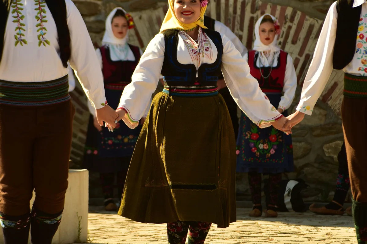 Dancers in colourful traditional costume performing outdoors, representative of folk dance generally